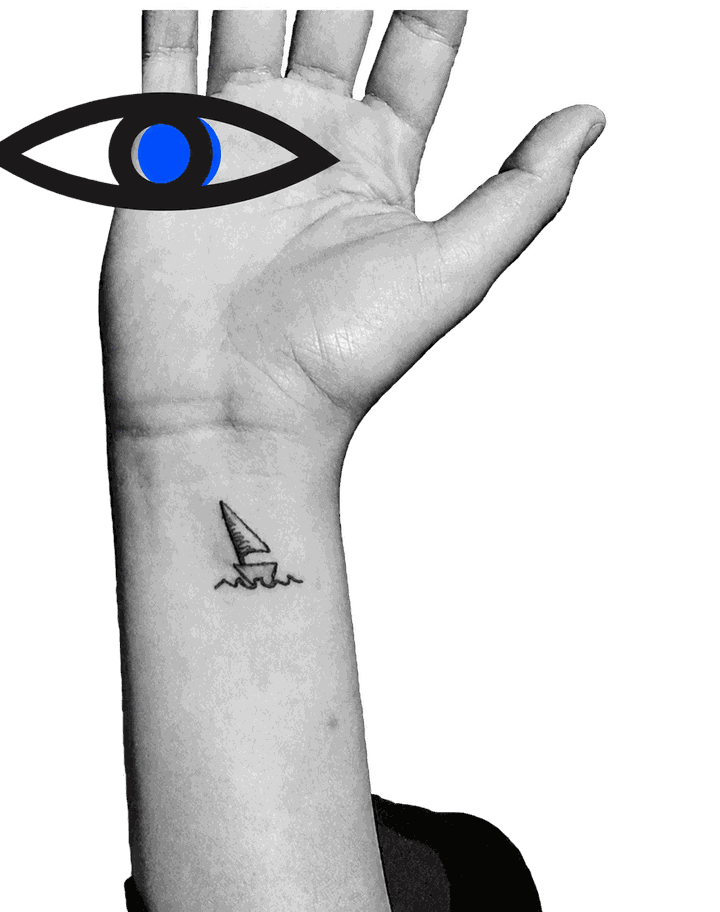 Reem's raised hand in black and white, with a blue-and-black eye glyph over the palm and a small sailboat tattoo on the wrist.