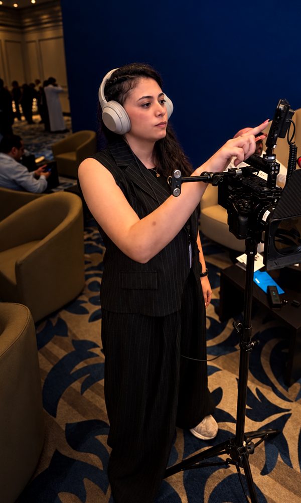 Reem Dissoky behind a cinema camera rig, filming on the event floor at FFCC KSA 2026.