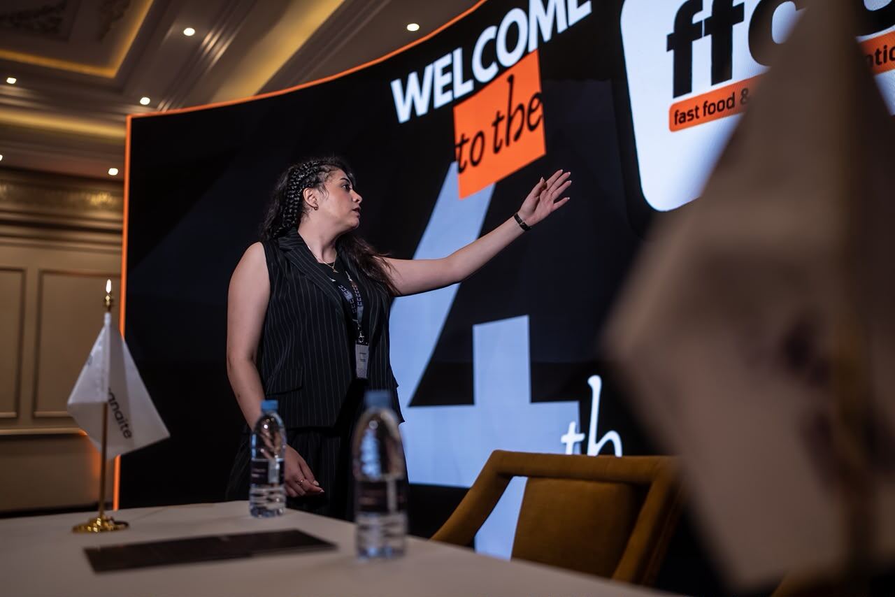 Reem on stage at FFCC, welcoming attendees to the event.